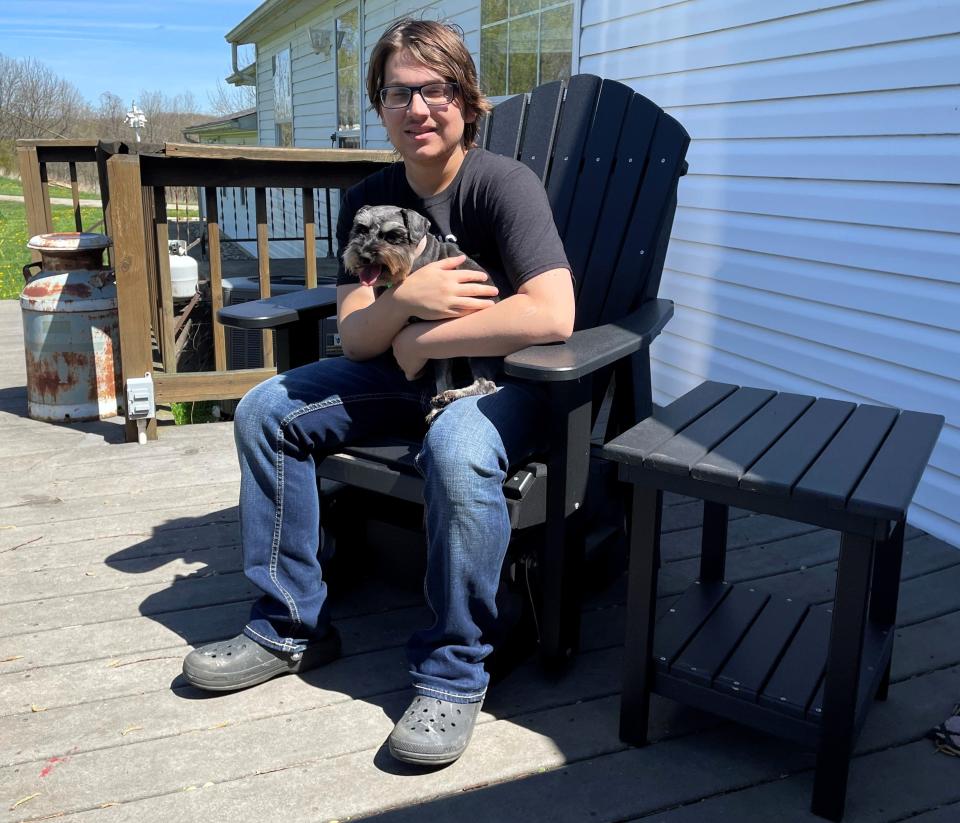 Gabe Gingerich of Warsaw enjoys a little sunshine and his dog Raven, a miniature schnauzer. Gabe has kidney failure and is in need of a  kidney from a living donor. The high school senior is holding down two jobs at Rise and Shine Market in Warsaw and the Mossy's Corner Drive-Thru in New Castle. To learn more more about an organ donation, visit osuwexmedlivingdonor.org.