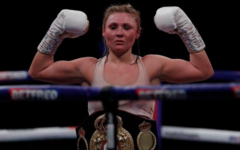 Shannon Courtenay celebrates with the belt after winning the fight against Ebanie Bridges. - REUTERS