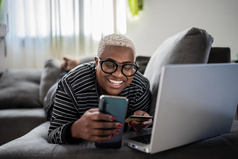 A person using their credit card to purchase something on their phone