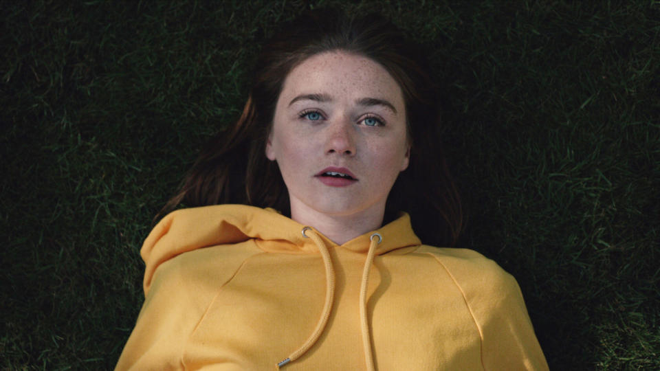 Jessica Barden laying in the grass on "The End of the F***ing World"