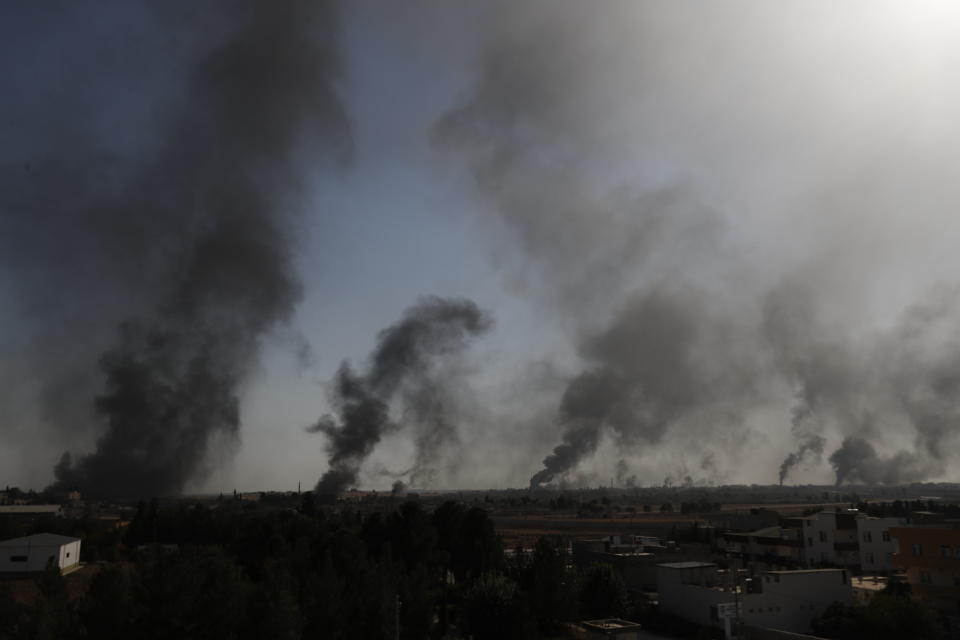 FILE-In this Thursday, Oct. 10, 2019 file photo, taken from the Turkish side of the border between Turkey and Syria, in Akcakale, Sanliurfa province, southeastern Turkey, smoke billows from targets inside Tal Abyad ,Syria during bombardment by Turkish forces. Since Turkey announced its incursion into neighbouring Syria to clear out Kurdish fighters last week, patriotic sentiment has run high with many public signs of support for the military. (AP Photo/Lefteris Pitarakis)