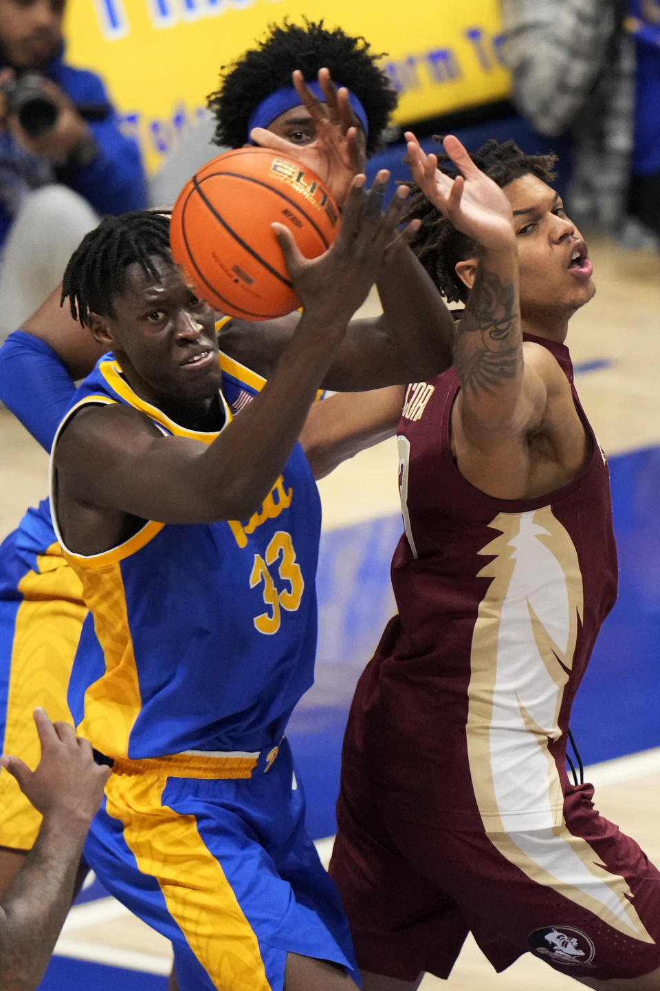 Pittsburgh center Federiko Federiko (33) battles for a rebound with Florida State forward Cam Corhen (3) during the second half of an NCAA college basketball game in Pittsburgh, Saturday, Jan. 21, 2023. Florida State won 71-64. (AP Photo/Gene J. Puskar)