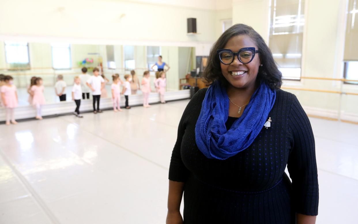 Sarah Taylor, executive director of Southold Dance Theater, poses while a dance class for the youngest students goes on behind her Nov. 14, 2022, at the Colfax Cultural Center in South Bend.