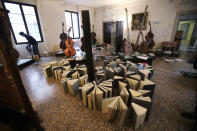 Volunteers try to save ancient music books by placing them to dry at the first floor of Venice Conservatory after recovering them from ground floor, Italy, Saturday, Nov. 16, 2019. High tidal waters returned to Venice on Saturday, four days after the city experienced its worst flooding in 50 years. Young Venetians are responding to the worst flood in their lifetimes by volunteering to help salvage manuscripts, clear out waterlogged books and lend a hand where needed throughout the stricken city.(AP Photo/Luca Bruno)