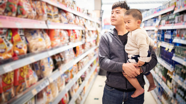 father and son browsing at grocery store