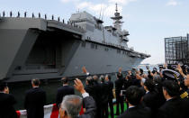 Officials of Defense Ministry see off Japan Maritime Self-Defense Force's (JMSDF) latest Izumo-class helicopter carrier DDH-184 Kaga after a handover ceremony for the JMSDF by Japan Marine United Corporation in Yokohama, Japan March 22, 2017. REUTERS/Toru Hanai