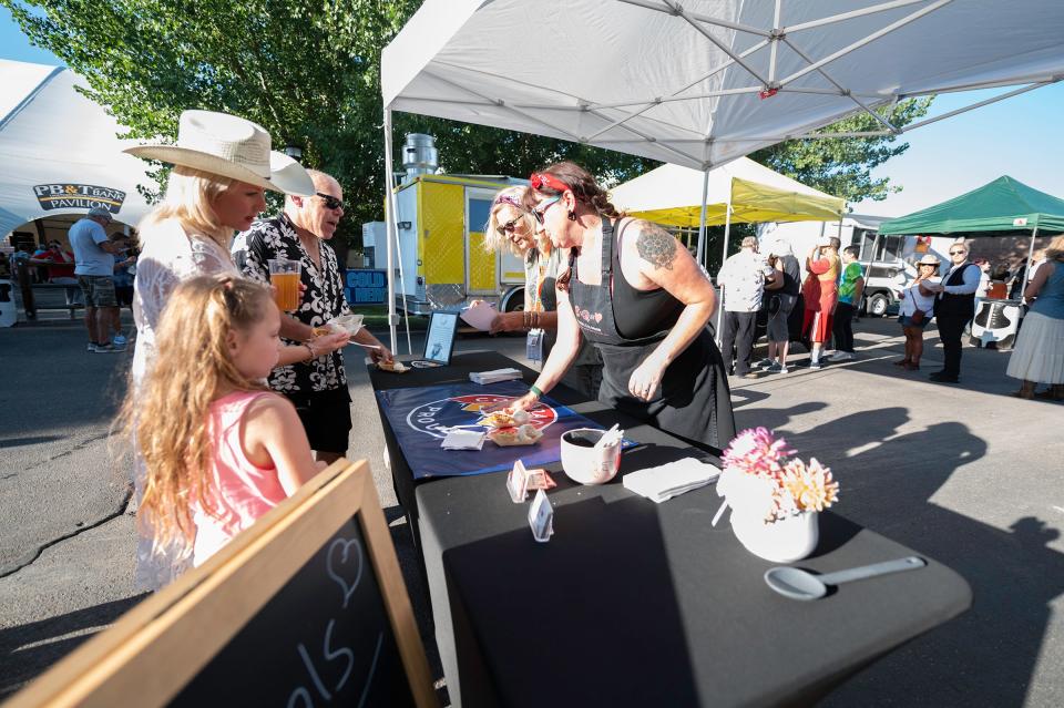 A group line up for an apple pie and ice cream at Anne's A'la Mode, a dessert food truck based out of Edgewater, during the Governor's Plate competition at the Colorado State Fair on Tuesday, August 29, 2023.