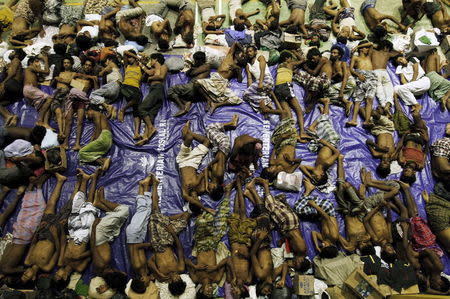 Migrants believed to be Rohingya rest inside a shelter after being rescued from boats at Lhoksukon in Indonesia's Aceh Province May 11, 2015. REUTERS/Roni Bintang