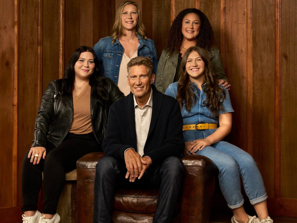 Gerry Turner, center, sits surrounded by his daughters and granddaughters.