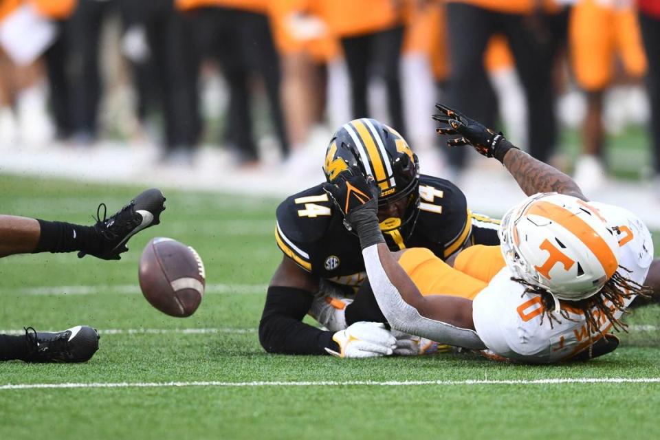 Tennessee Volunteers running back Jaylen Wright fumbles the football on a tackle by Missouri Tigers linebacker Triston Newson (No. 14) on Saturday at Faurot Field. Saul Young/News Sentinel/USA TODAY NETWORK