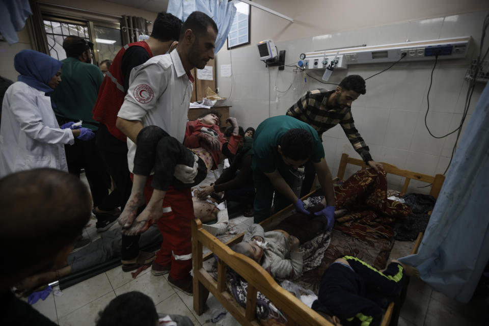 Palestinians wounded in the Israeli bombardment of the Gaza Strip arrive at a hospital in Khan Younis on Friday, Dec. 8, 2023. (AP Photo/Mohammed Dahman)