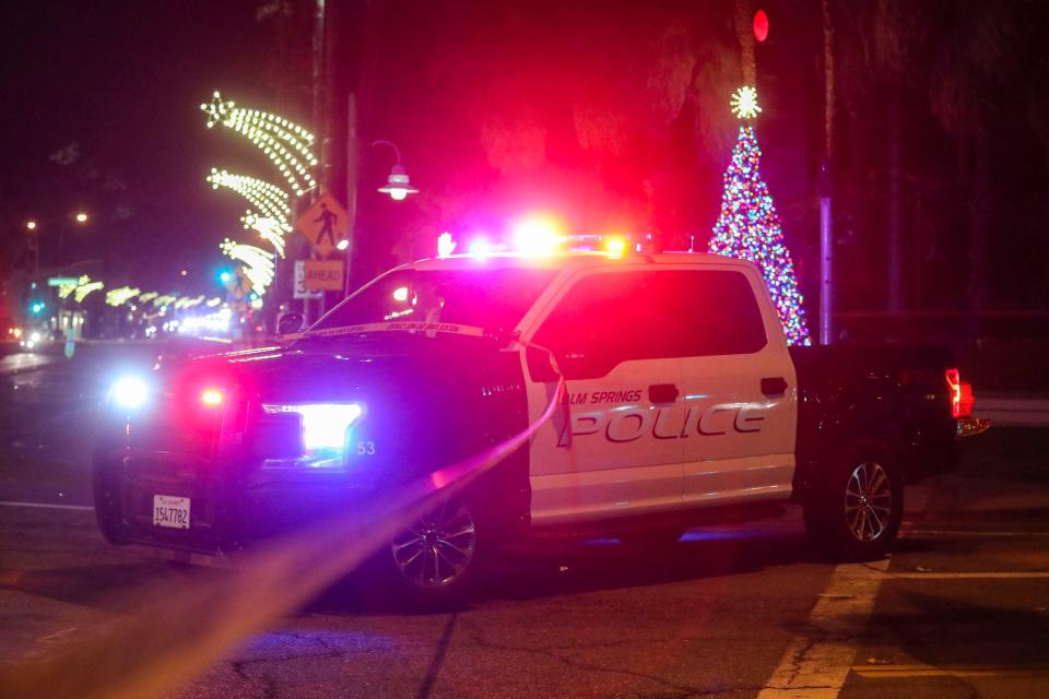 A Palm Springs police vehicle helps block traffic after a fatal crash at the intersection of North Palm Canyon and Alejo Road on Dec. 27, 2021.