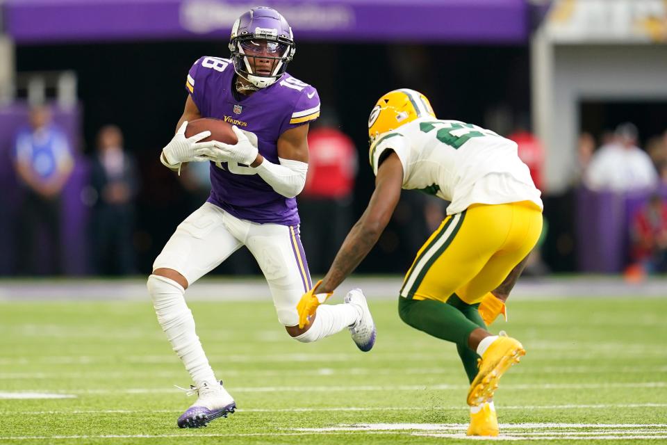 Minnesota Vikings wide receiver Justin Jefferson (18) carries the ball against Green Bay Packers cornerback Rasul Douglas (29) after catching a pass during the second half of an NFL football game, Sunday, Sept. 11, 2022, in Minneapolis.