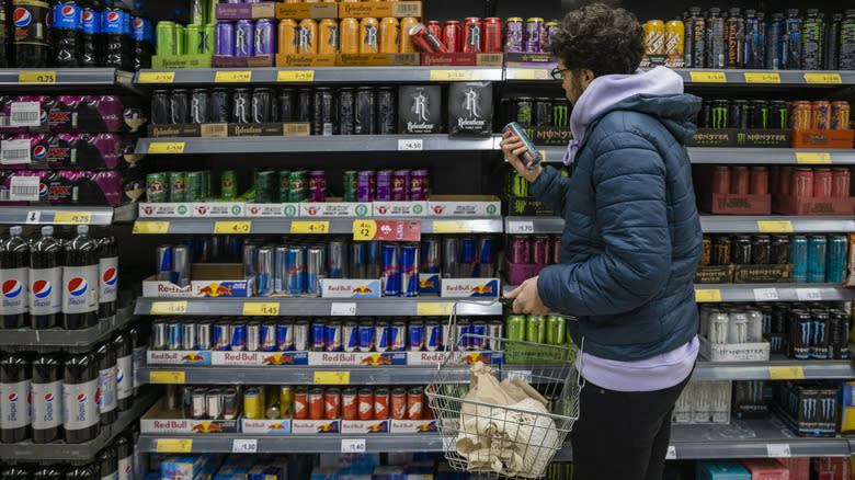 man shopping for energy drinks