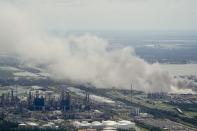 A chemical fire burns at a facility during the aftermath of Hurricane Laura Thursday, Aug. 27, 2020, near Lake Charles, La. (AP Photo/David J. Phillip)