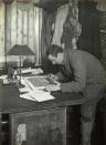 Edward Wilson, who died alongside Scott, was chief scientist on the expedition. He is pictured here at work in the hut they all shared. ©H Ponting photograph, Canterbury Museum, New Zealand.