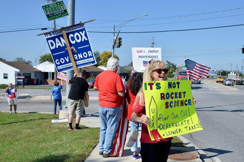 Nancy Allen, of Hagerstown, holds a sign outside the entrance to Volvo Group Trucks on Maugans Avenue in Hagerstown on Friday ahead of President Biden's visit.