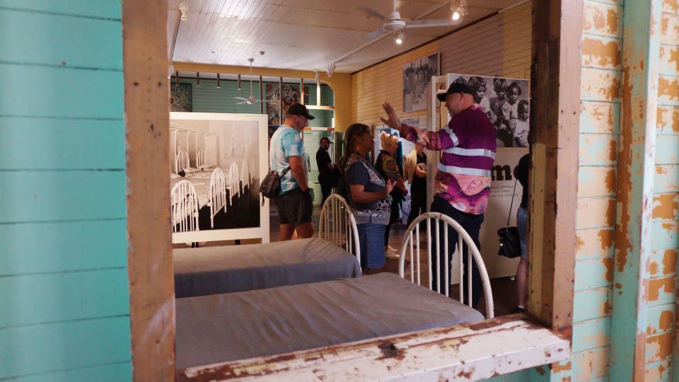 Tourists visiting the Ration Shed Museum are shown the interior of the old boys' dormitory. The girls' dormitory burned down in the 1990s. - Hilary Whiteman/CNN