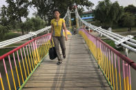 <p>A North Korean crosses the Pothong River via a suspended bridge at the start of a work day on July 19, 2017, in Pyongyang, North Korea. (Photo: Wong Maye-E/AP) </p>