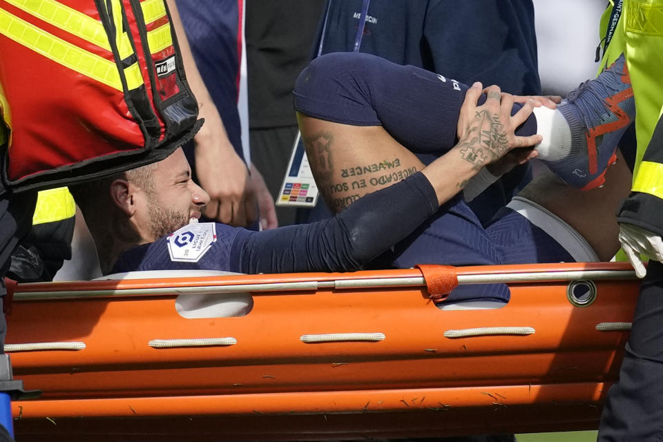 Neymar, do Paris Saint-Germain, é retirado do campo em uma maca após se machucar durante a partida de futebol da Ligue 1 entre Paris Saint-Germain e Lille no Parc des Princes, em Paris, França, domingo, 19 de fevereiro de 2023 (AP Photo/ Christophe Ena).