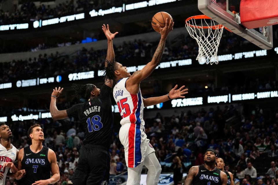 Pistons guard Marcus Sasser scores a layup against Mavericks forward Olivier-Maxence Prosper during the second half of the Pistons' 107-89 win on Friday, April 12, 2024, in Dallas.