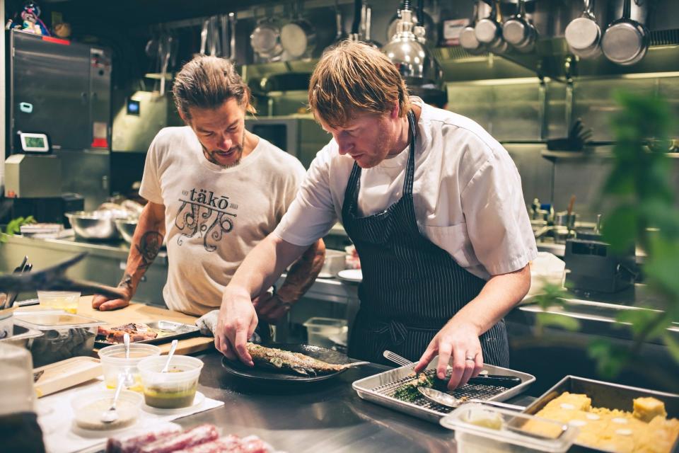 Two chefs prepare a fish course for Elements' "Chef's Tasting Menu."