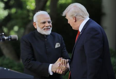 U.S. President Donald Trump (R) greets Indian Prime Minister Narendra Modi during their joint news conference in the Rose Garden of the White House in Washington, U.S., June 26, 2017. REUTERS/Carlos Barria