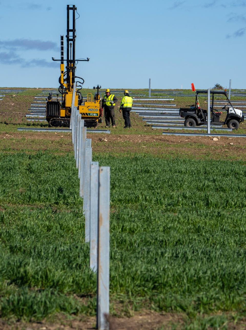 Workers place one of about 42,000 posts at the Springfield Solar Project in the Town of Lomira in Dodge County.