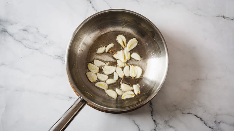 Sliced garlic in pan