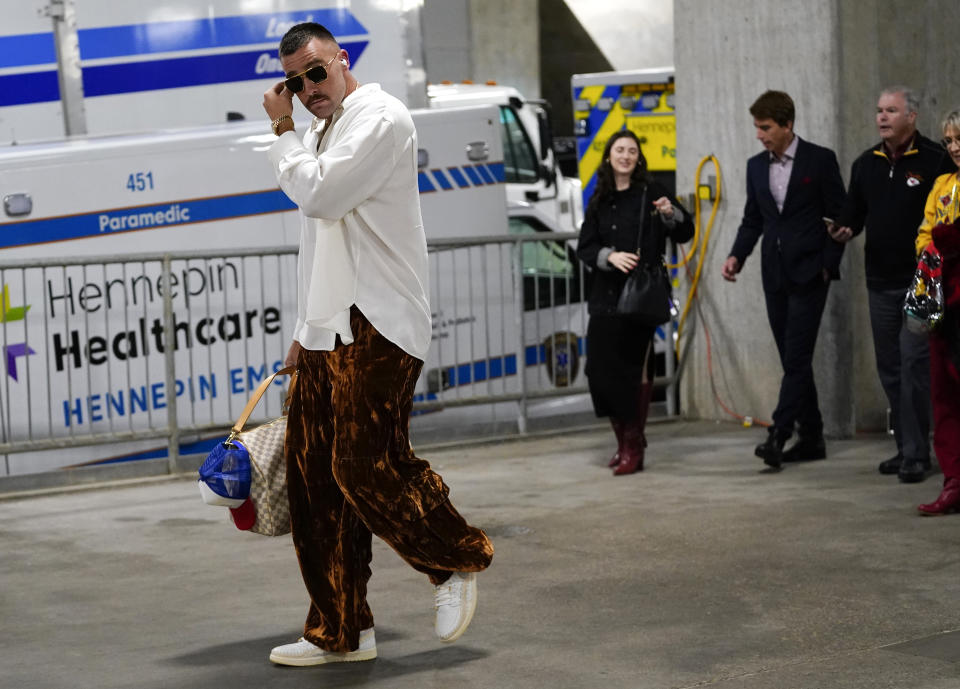 Kansas City Chiefs tight end Travis Kelce, left, arrives at U.S. Bank Stadium before an NFL football game against the Minnesota Vikings, Sunday, Oct. 8, 2023, in Minneapolis. (AP Photo/Abbie Parr)