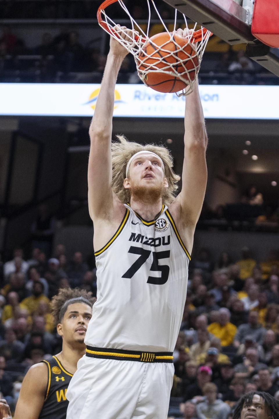 Missouri's Connor Vanover, top, dunks over Wichita State's Kenny Pohto during the second half of an NCAA college basketball game, Sunday, Dec. 3, 2023, in Columbia, Mo. (AP Photo/L.G. Patterson)