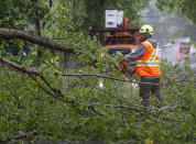 A worker removes a fallen tree blocking a road in Dartmouth, Nova Scotia. as Hurricane Dorian approaches on Saturday, Sept. 7, 2019. Despite gradually transitioning to a post-tropical storm, Dorian will continue to be as strong as a Category 1. (Andrew Vaughan/The Canadian Press via AP)