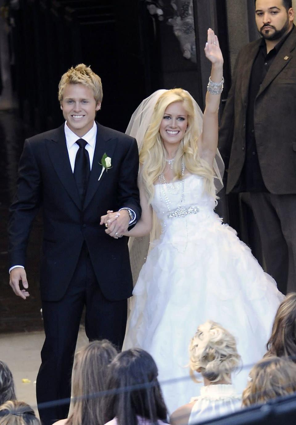 <p>In a moment that would be viewed by millions on reality TV, Heidi Montag and Spencer Pratt exchanged their vows in front of a dramatic crowd on MTV's <em>The Hills</em>. Leading up to the moment, there were rumors that Heidi would design her own gown, but for the her big day she wore a <a href="https://www.glamour.com/story/heidi-montags-wedding-dress-pa" rel="nofollow noopener" target="_blank" data-ylk="slk:Monique Lhuillier" class="link ">Monique Lhuillier</a> dress.</p>