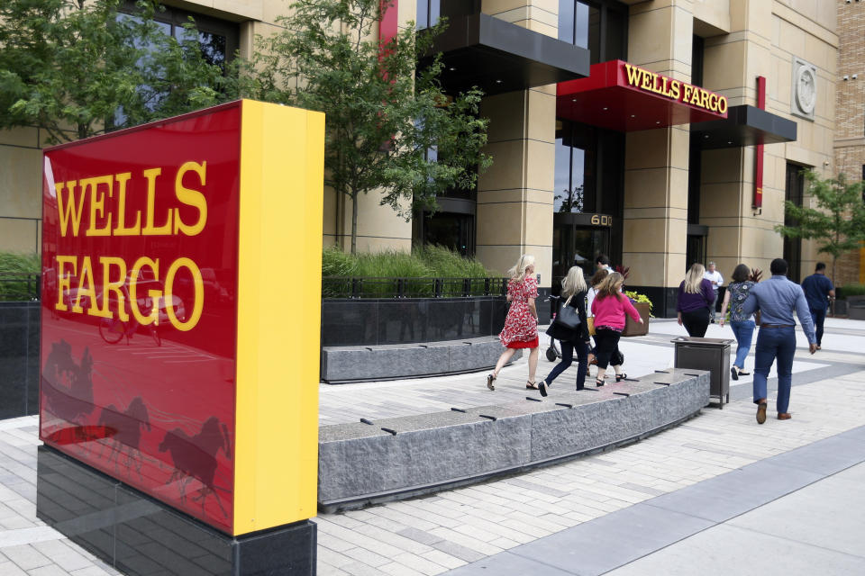 FILE - In this July 10, 2019, file photo a Wells Fargo building is shown in downtown Minneapolis. Wells Fargo & Co. reports financial results on Tuesday, Jan. 14, 2020. (AP Photo/Jim Mone, FIle)