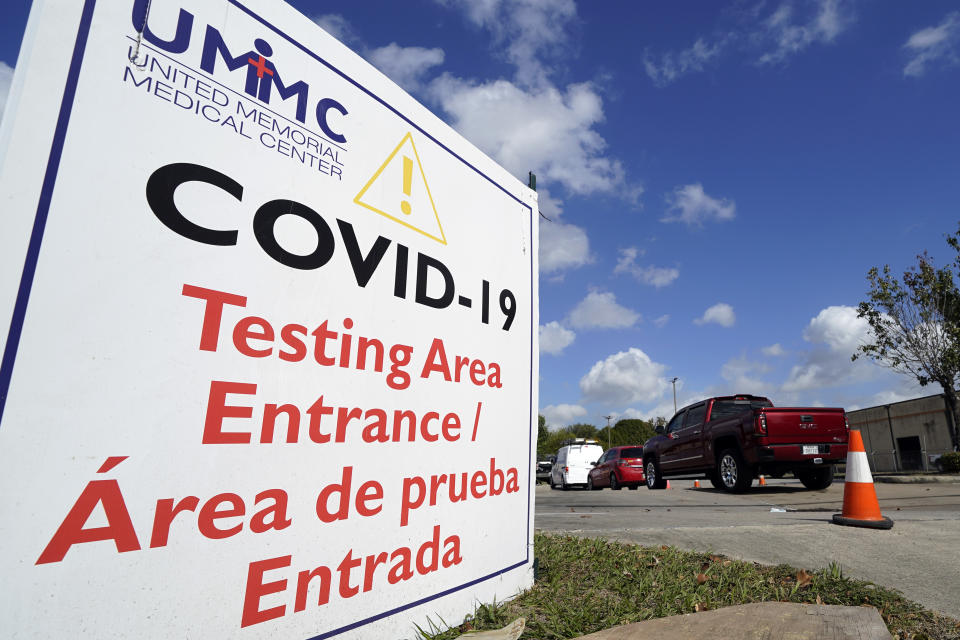 Drivers wait in line at a United Memorial Medical Center COVID-19 testing site Thursday, Nov. 19, 2020, in Houston. Texas is rushing thousands of additional medical staff to overworked hospitals as the number of hospitalized COVID-19 patients increases. (AP Photo/David J. Phillip)