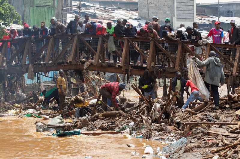 Residents recover their belongings after the Nairobi river burst its banks in the Mathare Valley settlement in Nairobi