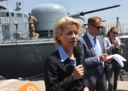 German Defense Minister Ursula von der Leyen, left, stands in front of a German UNIFIL vessel as she reads a statement, at the seaport of Beirut, Lebanon, Thursday April 24, 2014. Leyen is in Lebanon to meet with Lebanese officials and to visit the German UNIFIL navy troops. Germany has been a contributor since 2006 to the UNIFIL maritime mission in Lebanon which aims at supporting the Lebanese navy in security Lebanon’s maritime borders. (AP Photo/Hussein Malla)