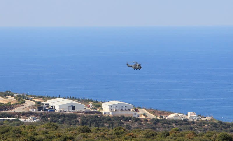 An aircraft flies over a base for U.N. peacekeepers of the United Nations Interim Force in Lebanon (UNIFIL) in Naqoura