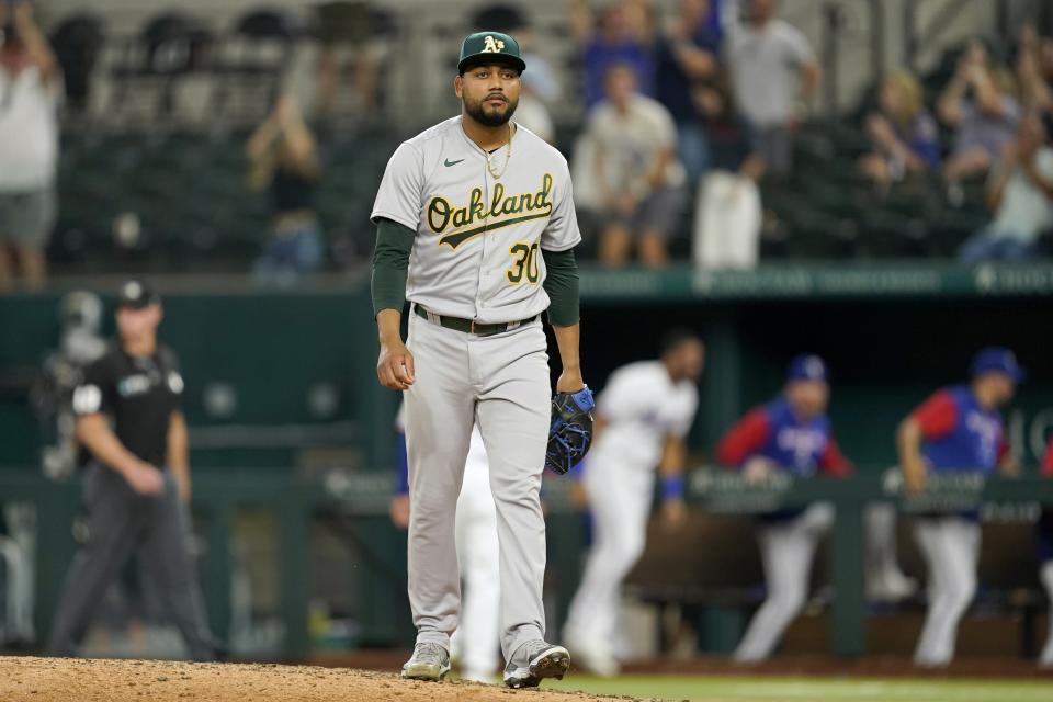 Oakland Athletics relief pitcher Joel Payamps walks off the mound after giving up a home run to Texas Rangers' Mark Mathias during the ninth inning of a baseball game in Arlington, Texas, Tuesday, Sept. 13, 2022. The Rangers won 8-7. (AP Photo/Tony Gutierrez)