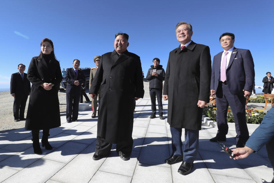 South Korean President Moon Jae-in, second from right, stands with North Korean leader Kim Jong Un, second from left, and his wife Ri Sol Ju, left, on the Mount Paektu in North Korea, Thursday, Sept. 20, 2018. (Pyongyang Press Corps Pool via AP)