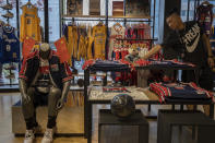 In this Friday, Oct. 11, 2019, photo, a sales person adjust a mascot doll at a NBA merchandise store in Beijing. When Houston Rockets' general manager Daryl Morey tweeted last week in support of anti-government protests in Hong Kong, everything changed for NBA fans in China. A new chant flooded Chinese sports forums: "I can live without basketball, but I can't live without my motherland."(AP Photo/Ng Han Guan)