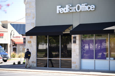 Law enforcement personnel are seen outside a FedEx Store which was closed for investigation, in Austin, Texas, U.S., March 20, 2018. REUTERS/Sergio Flores