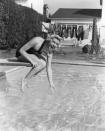 <p>Doris Day gets a feel for the water temperature before diving into her swimming pool in 1940. </p>