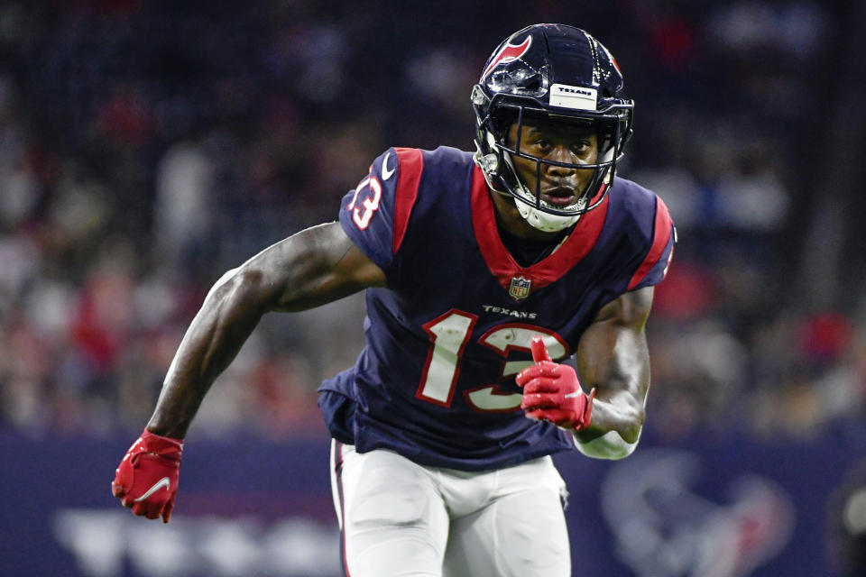 FILE - In this Saturday, Aug. 28, 2021, file photo, Houston Texans wide receiver Brandin Cooks (13) runs a route against the Tampa Bay Buccaneers during the first half of an NFL preseason football game in Houston. Cooks is giving back to QBs and other players by introducing them to a new form of light therapy that he uses for his anxiety and sleep issues called an Allay Lamp. (AP Photo/Justin Rex, File)