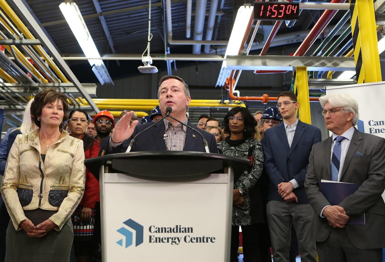 Former Alberta premier Jason Kenney, centre, addresses attendees at a press conference to announce the launch of the Canadian Energy Centre at SAIT in Calgary on Dec. 11, 2019, flanked by former energy minister Sonya Savage, left, and Tom Olsen, managing director of the Canadian Energy Centre. Kenney  opened the province's energy war room to fight what he called a campaign of lies about the province's energy industry.  (Greg Fulmes/The Canadian Press - image credit)