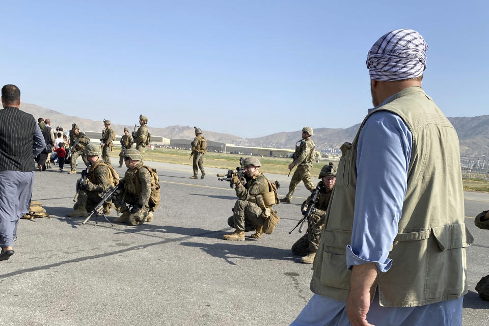 U.S soldiers take a position to guard along a perimeter at the international airport in Kabul, Afghanistan, Monday, Aug. 16, 2021. On Monday, the U.S. military and officials focus was on Kabul’s airport, where thousands of Afghans trapped by the sudden Taliban takeover rushed the tarmac and clung to U.S. military planes deployed to fly out staffers of the U.S. Embassy, which shut down Sunday, and others. (AP Photo/Shekib Rahmani)