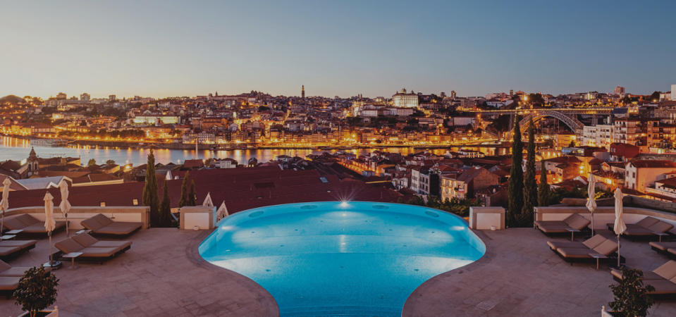 <p>Courtesy of The Yeatman</p><p>The Yeatman is a luxury wine hotel and spa in Porto with spectacular views over the UNESCO World Heritage city and the Douro River. Member of the prestigious Relais & Châteaux collection of hotels and distinguished with two Michelin Stars, The Yeatman Hotel is widely regarded as the <em>best hotel in Porto</em> and is a unique and distinctive landmark in the world of classic luxury hotels.<br><br>Set amidst the Port wine lodges, The Yeatman nestles on a hill, overlooking <a href="https://www.the-yeatman-hotel.com/en/porto/" rel="nofollow noopener" target="_blank" data-ylk="slk:Porto;elm:context_link;itc:0;sec:content-canvas" class="link ">Porto</a> and is set within 7 acres of land, and has outdoor and indoor infinity swimming pools.<br>All of our <a href="https://www.the-yeatman-hotel.com/en/rooms-suites/" rel="nofollow noopener" target="_blank" data-ylk="slk:spacious rooms and suites;elm:context_link;itc:0;sec:content-canvas" class="link ">spacious rooms and suites</a> have a terrace or balcony with views over Porto.<br></p><p>The Yeatman is a haven for wine lovers and the prime destination for those wishing to explore depth and variety of Portuguese wines.<br></p><p>The cellars of The Yeatman house one of the most comprehensive collections of Portuguese wines. The hotel has established partnerships with many of <a href="https://www.the-yeatman-hotel.com/en/wine/partners/" rel="nofollow noopener" target="_blank" data-ylk="slk:Portugal's finest producers;elm:context_link;itc:0;sec:content-canvas" class="link ">Portugal's finest producers</a> who actively participate in The Yeatman's programme of tastings, seminars and wine dinners. These partner wineries also sponsor individual rooms and suites. Intriguing pictures and objects provide insights into each winery's unique history and environment and add a discreet individual accent to each guest room.<br><br>Complementing The Yeatman's own wine activities, visits can be arranged to leading vineyards and estates in the Douro Valley, Minho, Dão and Bairrada wine regions, all easily accessible by road.<br><br>The wine theme extends to <a href="https://www.the-yeatman-hotel.com/en/porto-spa/" rel="nofollow noopener" target="_blank" data-ylk="slk:The Yeatman Wine Spa;elm:context_link;itc:0;sec:content-canvas" class="link ">The Yeatman Wine Spa</a> with its exclusive skincare products and therapies.<br>Guests are able to discuss Portuguese wines with the hotel's knowledgeable and friendly experts who are on hand to guide guests in their discovery of Portugal's diverse and individual wine regions, with their unique traditions and wealth of different styles.</p><p><a href="https://www.the-yeatman-hotel.com/" rel="nofollow noopener" target="_blank" data-ylk="slk:Click here to make a reservation;elm:context_link;itc:0;sec:content-canvas" class="link ">Click here to make a reservation</a></p>