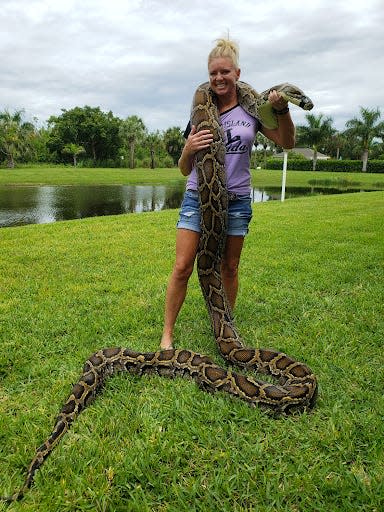 Amy Siewe holding a 17'3" python.