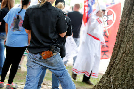 Members of the Ku Klux Klan openly wear firearms as they rally in opposition to city proposals to remove or make changes Confederate monuments in Charlottesville, Virginia, U.S. July 8, 2017. REUTERS/Jonathan Ernst