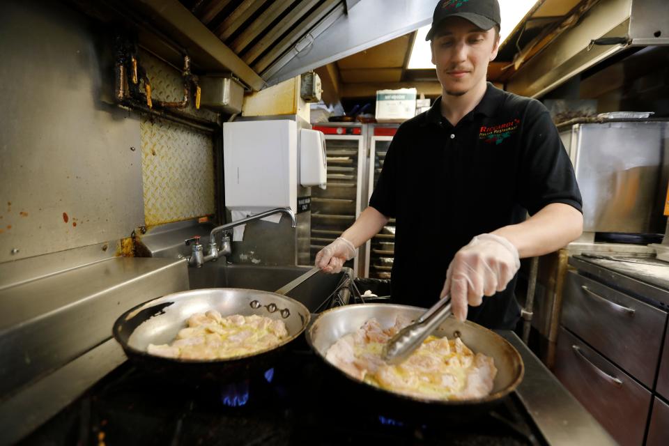 Saute chef, Cameron Callahan, prepares chicken for a chicken broccoli and ziti dish at Riccardi's Restaurant on Hathaway Road in New Bedford.